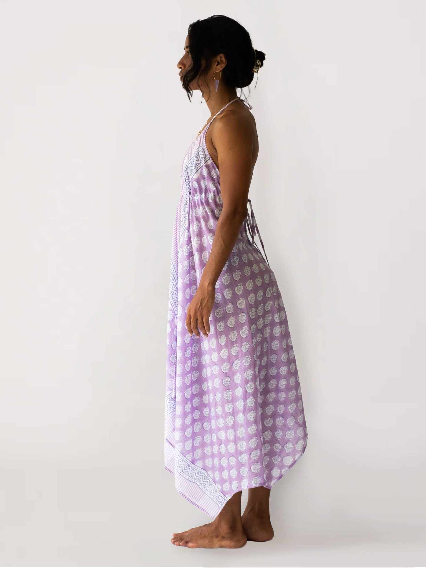 Woman wearing a purple checkered dress against a white background