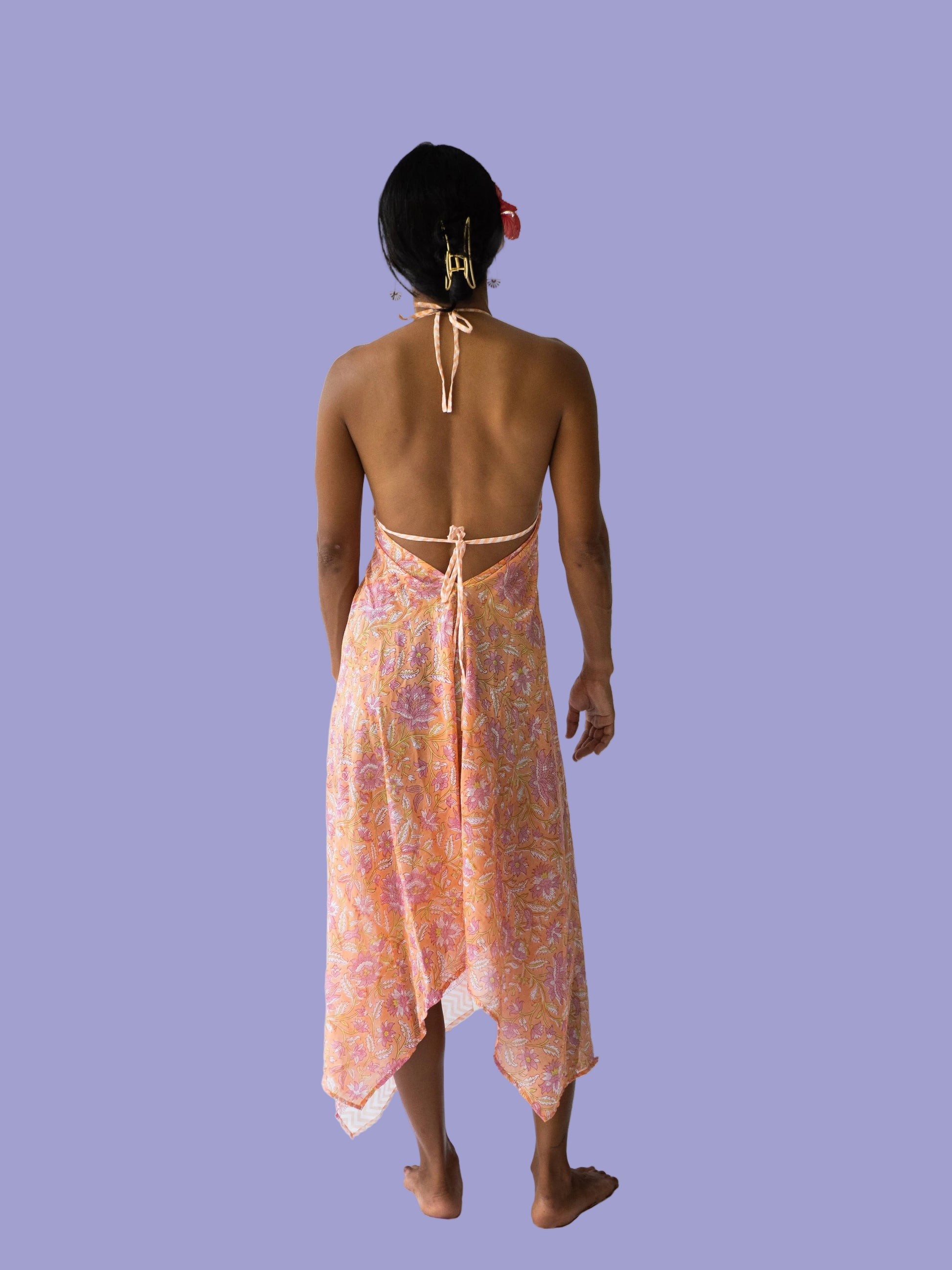Woman wearing a floral patterned dress on a white background