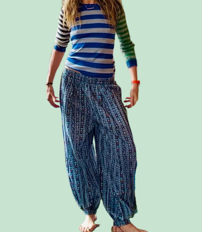 Petra wearing a striped shirt and balloon pants .